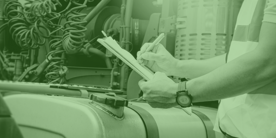 Inspector revisando una lista de verificación en una estación de carga de combustible para transporte de carga de forma confiable